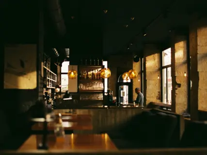 A warm, busy dining room with close-set tables