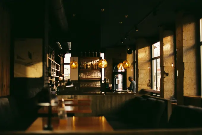 A warm, busy dining room with close-set tables