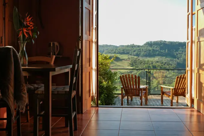 A long table laid for lunch on a stone terrace above the vines