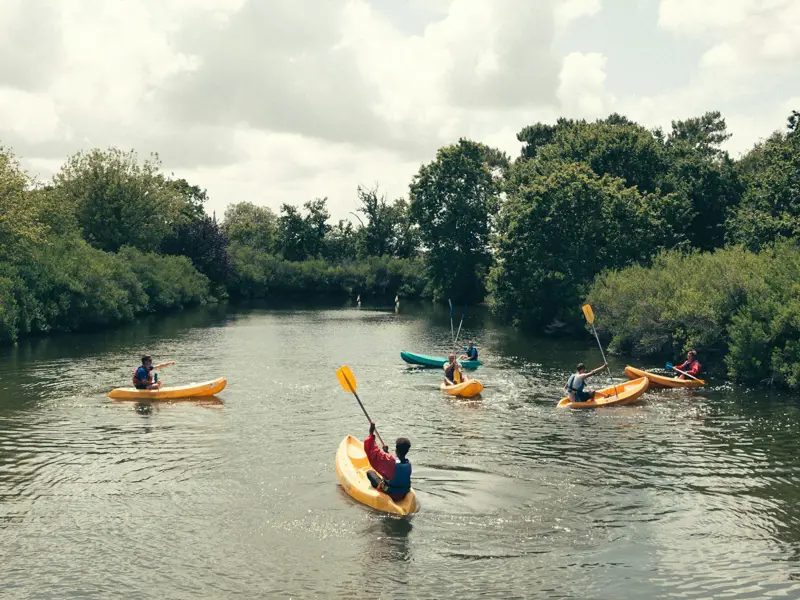 Young people paddling on calm water