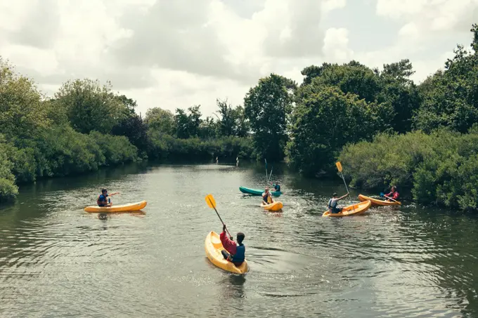 Young people paddling on calm water