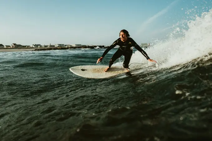 An instructor walking a beginner through a pop-up on the beach