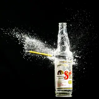 A drink being poured, caught mid-splash
