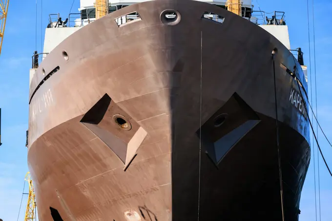 A vessel under construction in dock with staging up both sides