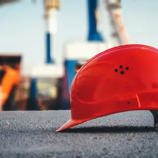 A fabricator in helmet and visor at the welding bay