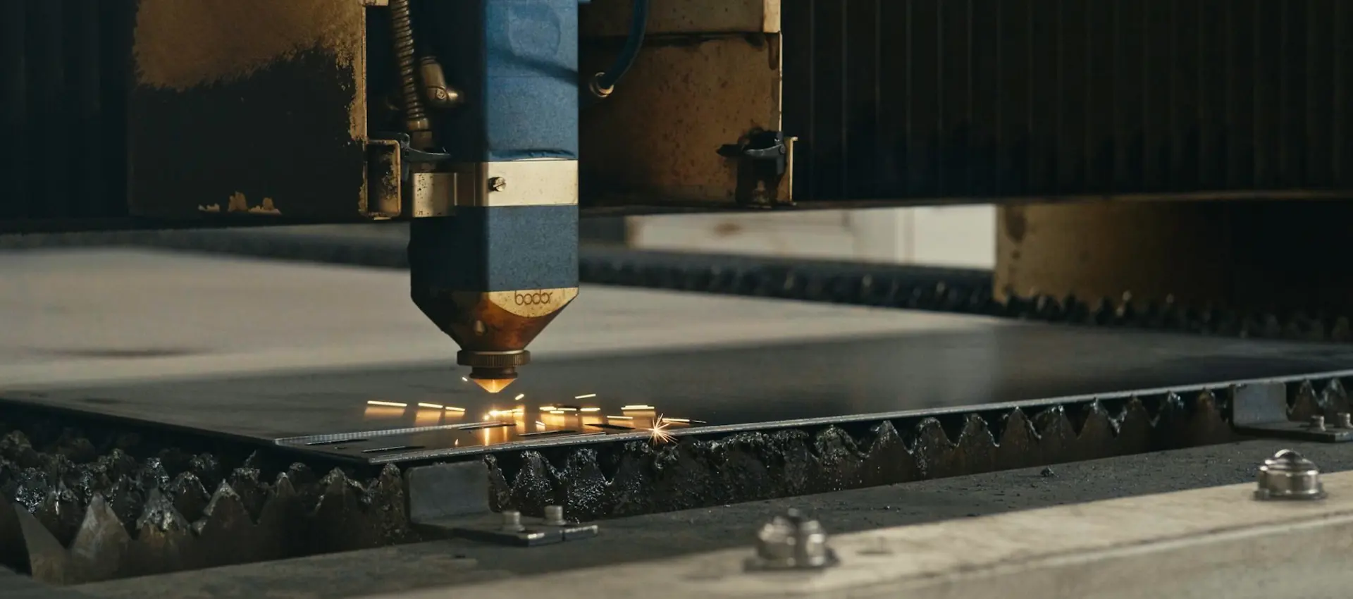 A laser head cutting a profile out of a steel sheet