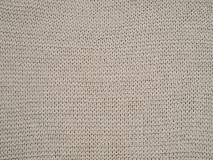 The texture of a heavy knitted jumper, close in