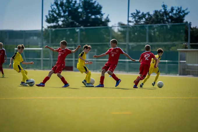 Children mid-game on a public playing field