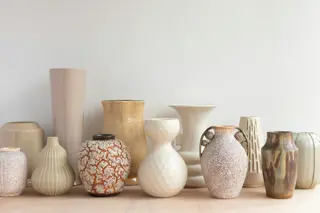 Ceramic vessels arranged along a shelf