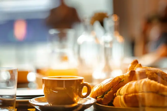 Breakfast laid out on a wooden table in low morning light