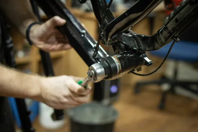 Young people repairing bicycles together in a workshop