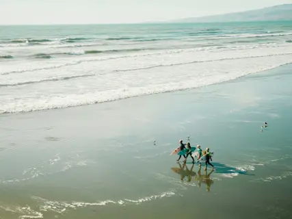 A group of children on the beach at the end of a session
