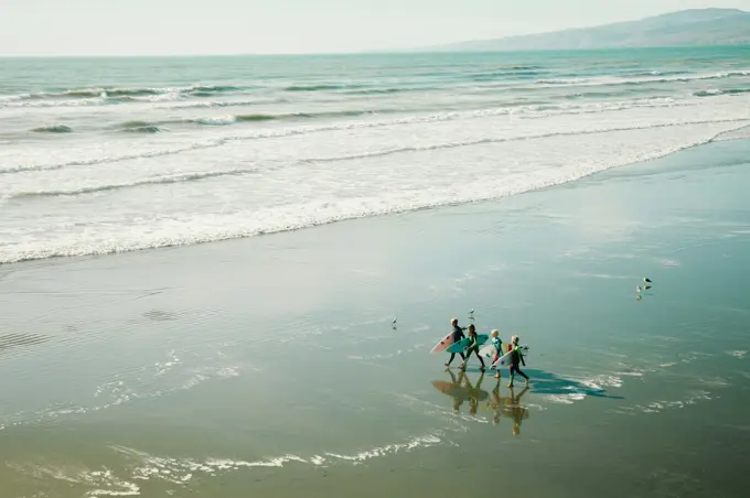 A group of children on the beach at the end of a session